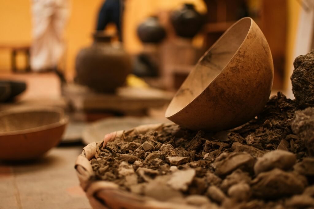 Close-up of traditional clay pottery and vessels in a warm-toned artisan workshop.